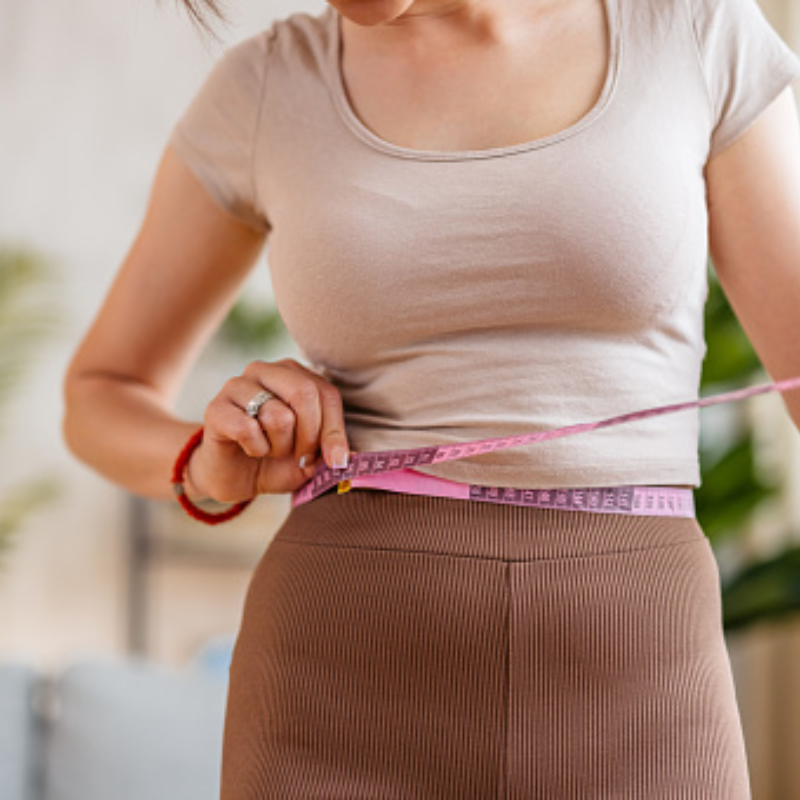 woman down a size after weight management coaching