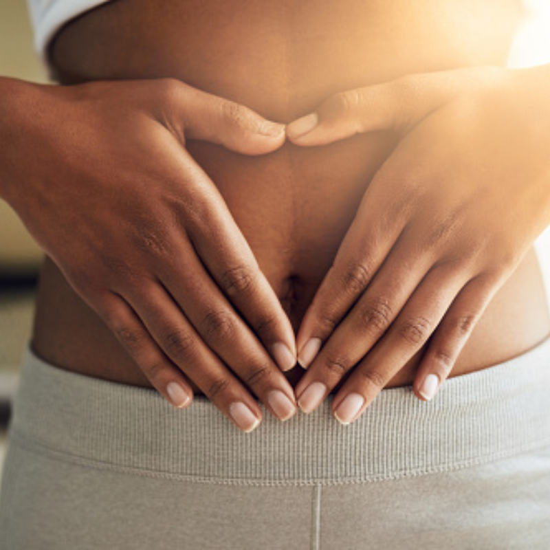 woman holding uterus in heart hands symbolizing cyclic coaching regulating hormones